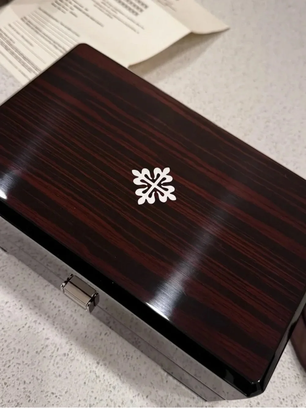 Patek Philippe Brown and Black High-Gloss Wood Watch Box with Silver Emblem